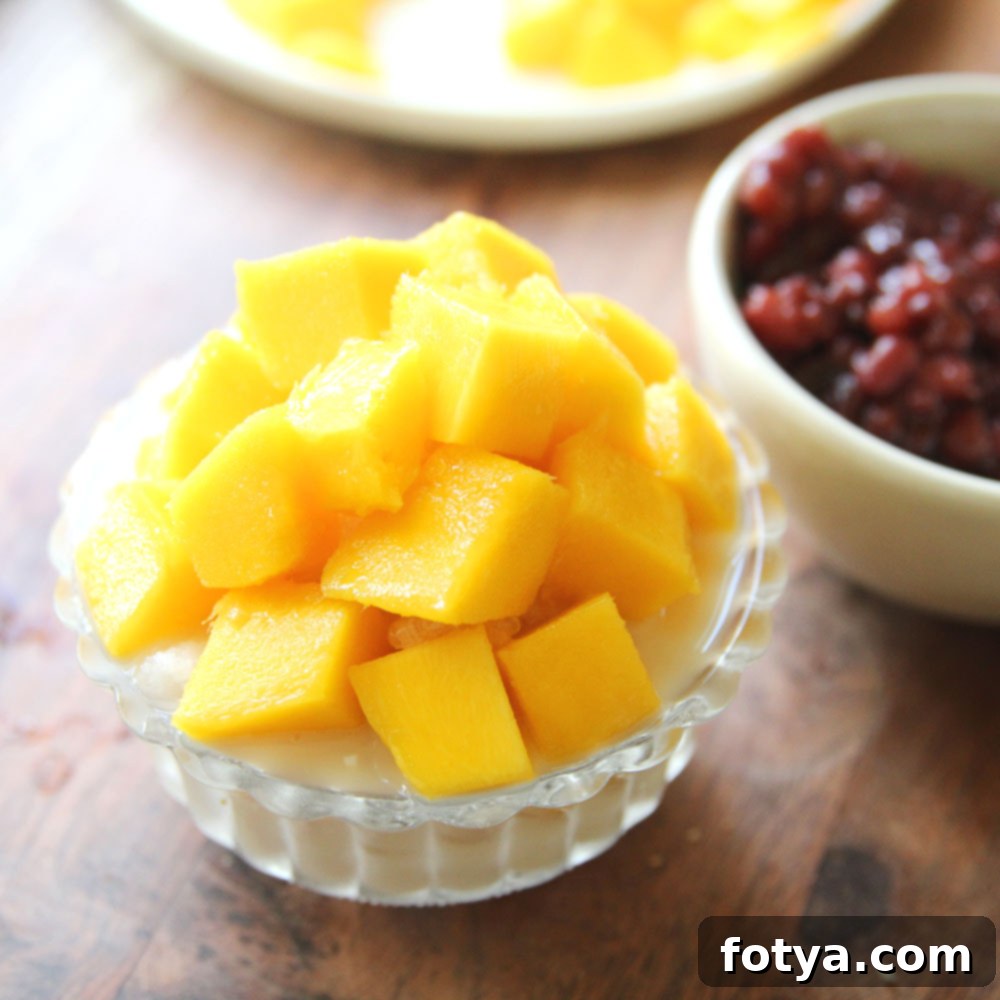 Bingsu Μάνγκο με Κόντζακ: Η Υγιεινή Δροσιά 5 Τοποθετήστε κύβους μάνγκο πάνω από τον πάγο